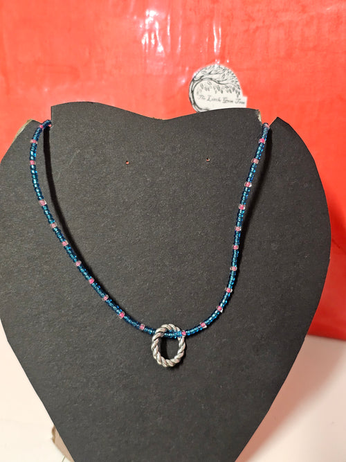 blue and pink chain witha silver circle pendent