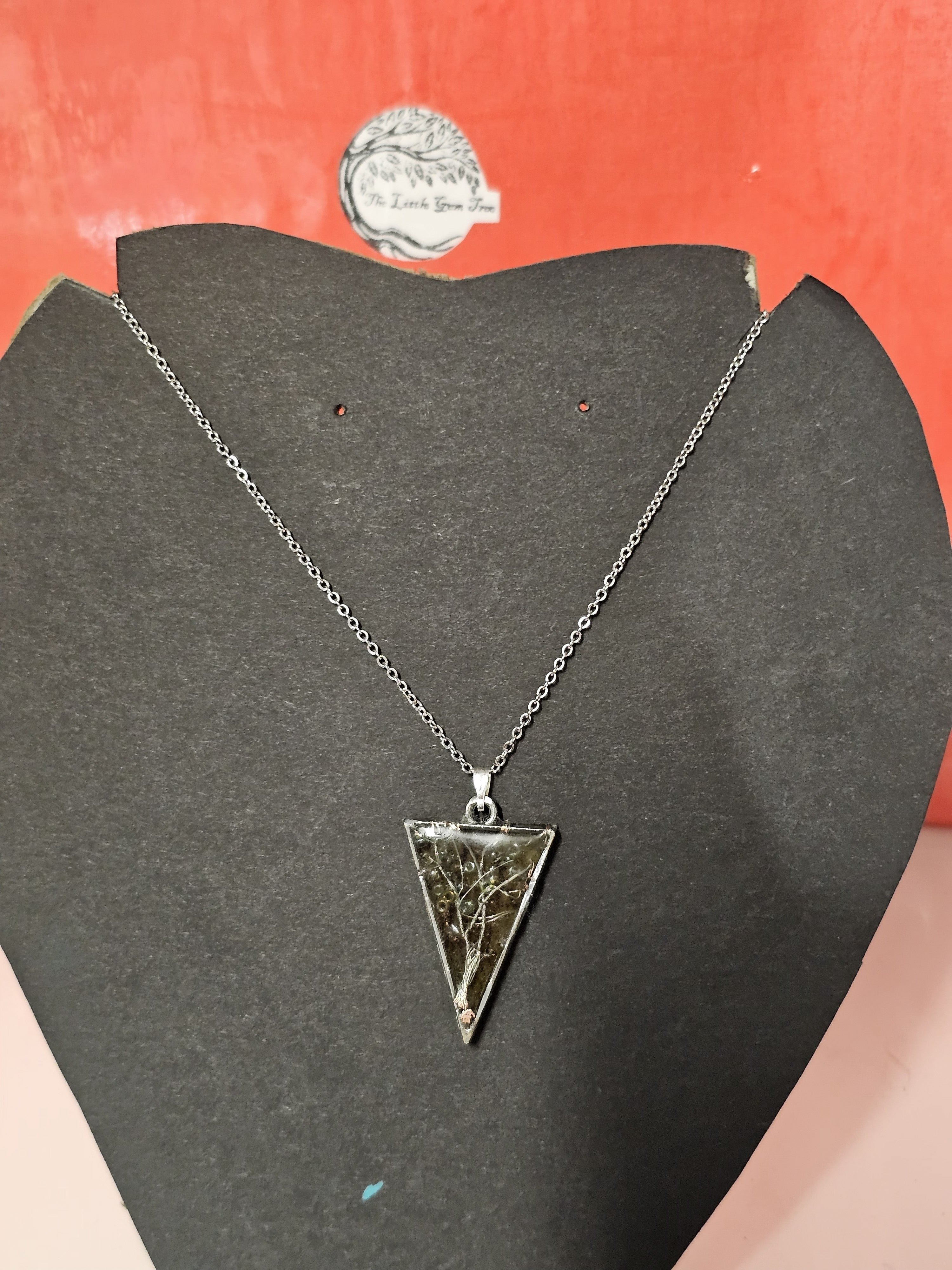 tree of life in resin with orange leaf background in a triangle pendent