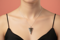 tree of life in resin with orange leaf background in a triangle pendent