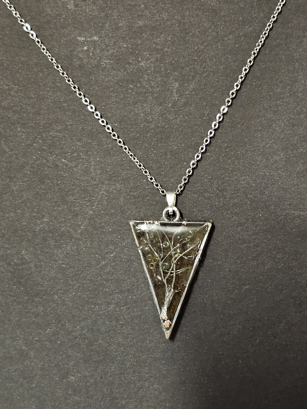 tree of life in resin with orange leaf background in a triangle pendent