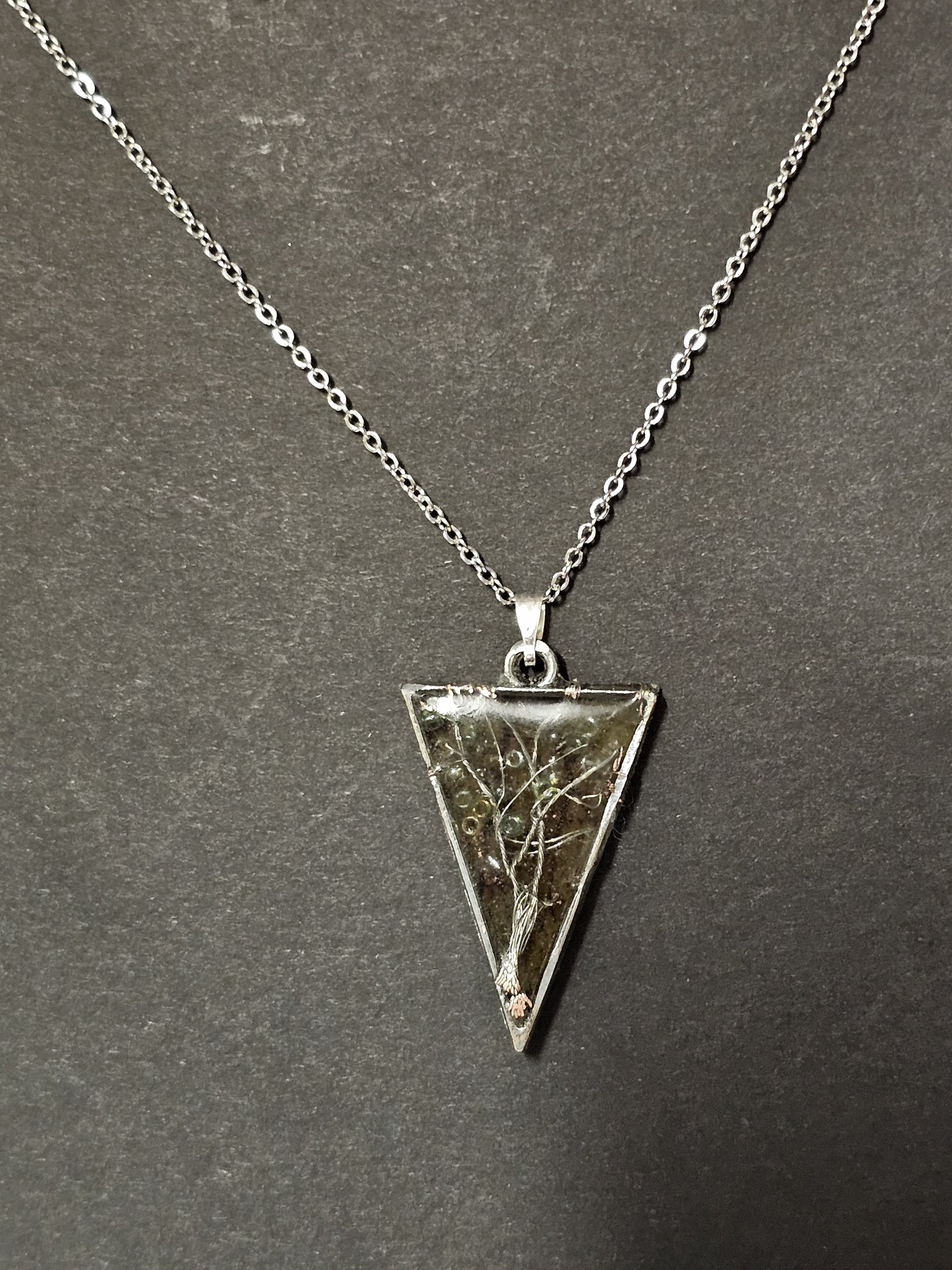 tree of life in resin with orange leaf background in a triangle pendent
