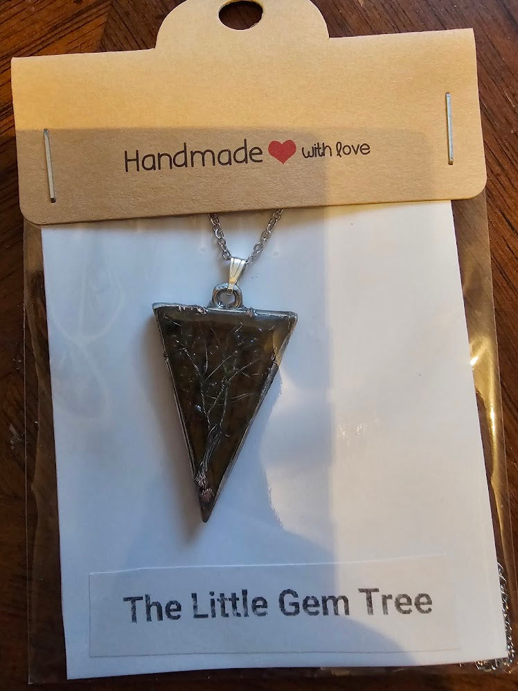 tree of life in resin with orange leaf background in a triangle pendent