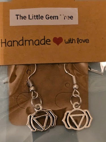 Silver geometric earrings on a 'The Little Gem Tree' branded card against a gray background