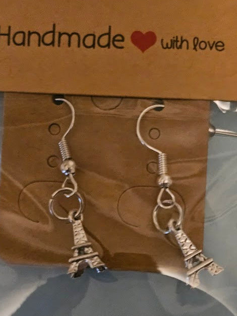 Eiffel Tower earrings on a 'The Little Gem Tree' branded card.