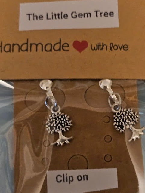 Pair of silver earrings with tree design on a 'The Little Gem Tree' branded card.