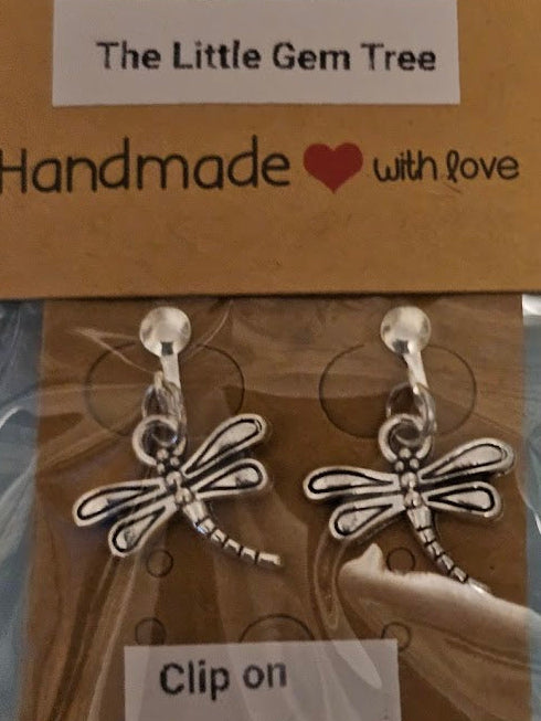 Dragonfly-shaped earrings on a 'The Little Gem Tree' branded card.