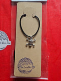 skull and cross bones pendent on cord