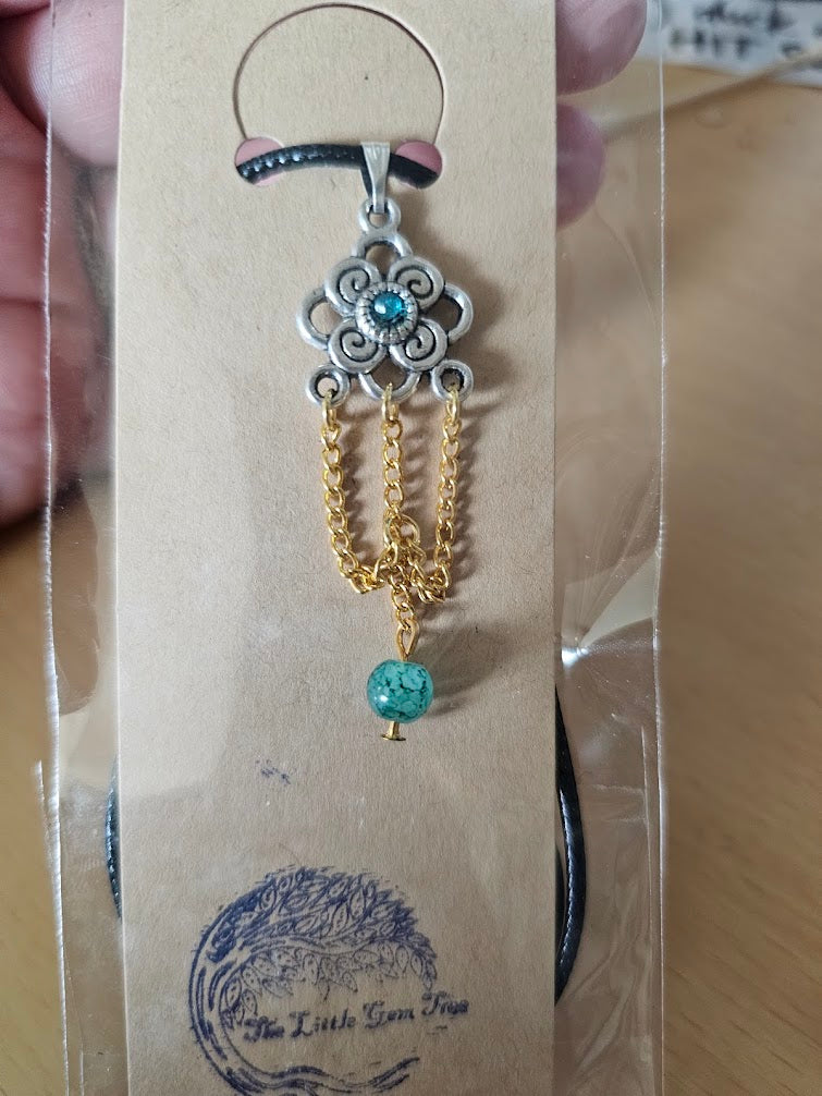 unique shape featuring a green gem